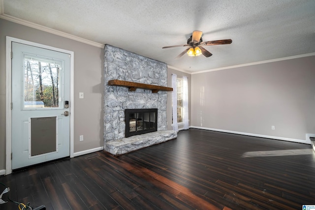 unfurnished living room featuring ceiling fan, a fireplace, dark wood-type flooring, and a textured ceiling