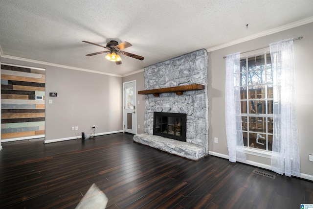 unfurnished living room with a textured ceiling, a stone fireplace, ceiling fan, and dark hardwood / wood-style floors