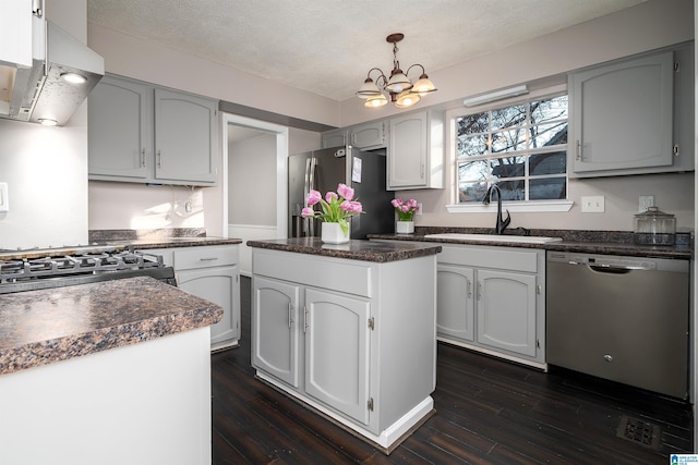 kitchen with dark hardwood / wood-style flooring, a center island, sink, and stainless steel appliances