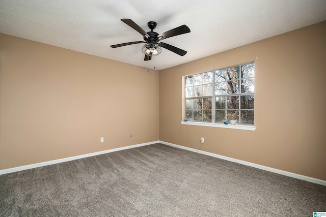 spare room featuring carpet flooring, ceiling fan, and a textured ceiling