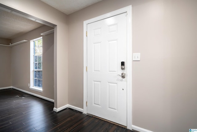 entrance foyer featuring a textured ceiling and dark hardwood / wood-style flooring