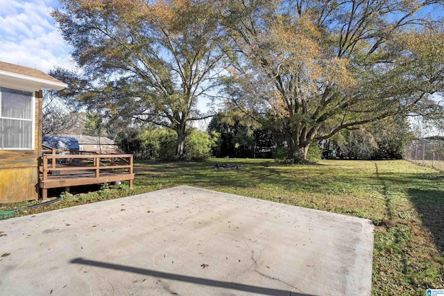 view of yard featuring a wooden deck and a patio area