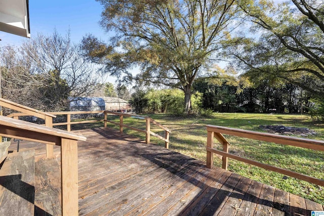 wooden deck featuring a yard