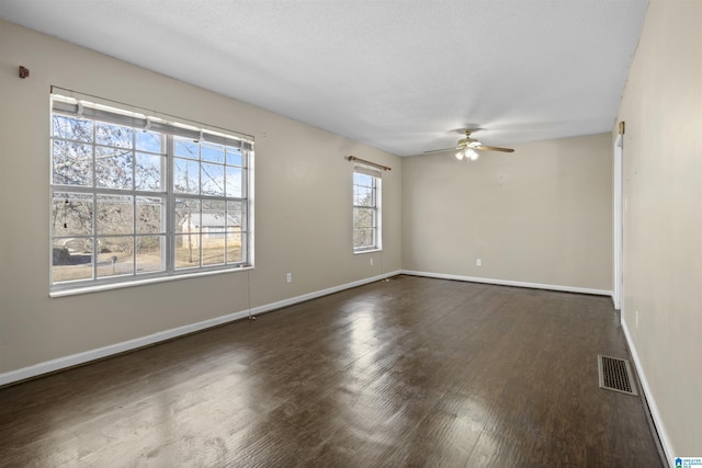 unfurnished room with dark hardwood / wood-style floors and ceiling fan