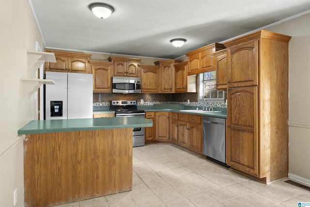 kitchen featuring appliances with stainless steel finishes, tasteful backsplash, ornamental molding, sink, and a center island