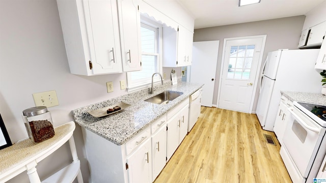 kitchen with light stone countertops, sink, light hardwood / wood-style floors, white appliances, and white cabinets