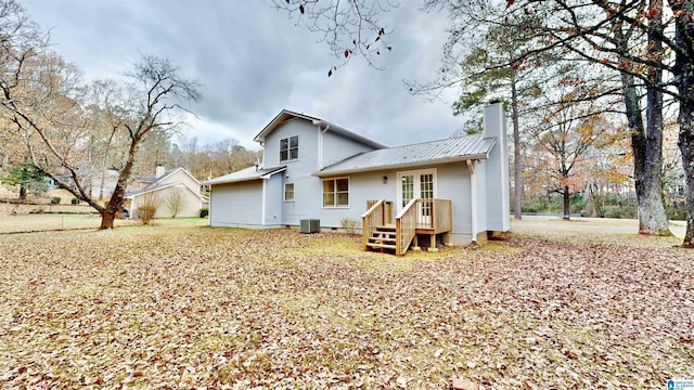 rear view of property with central AC and french doors