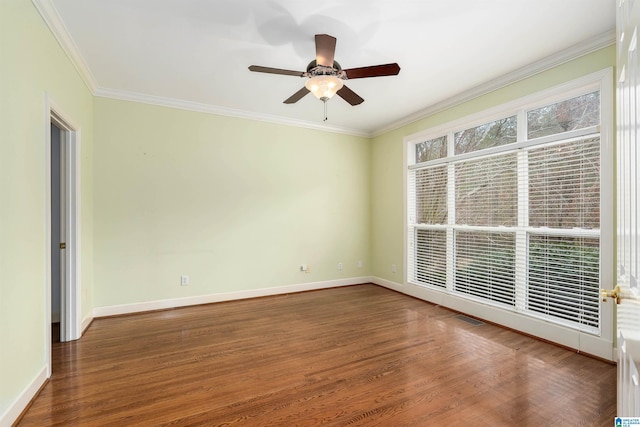 empty room with crown molding, ceiling fan, and dark wood-type flooring