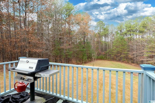 wooden deck with a grill and a yard