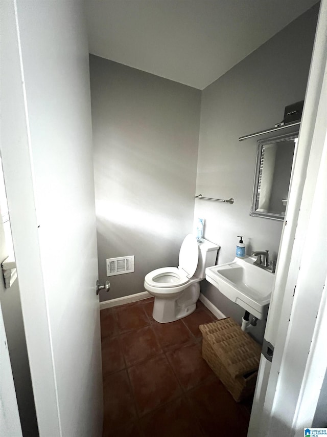 bathroom with tile patterned flooring, toilet, and sink