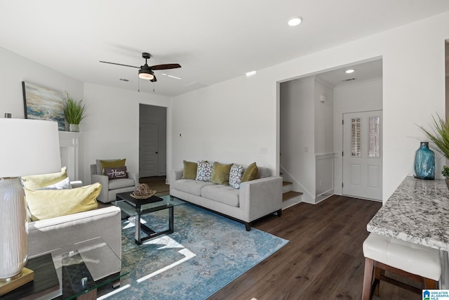 living room with ceiling fan, dark hardwood / wood-style flooring, and ornamental molding