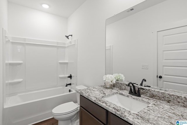 full bathroom featuring hardwood / wood-style floors, vanity, shower / bathtub combination, and toilet