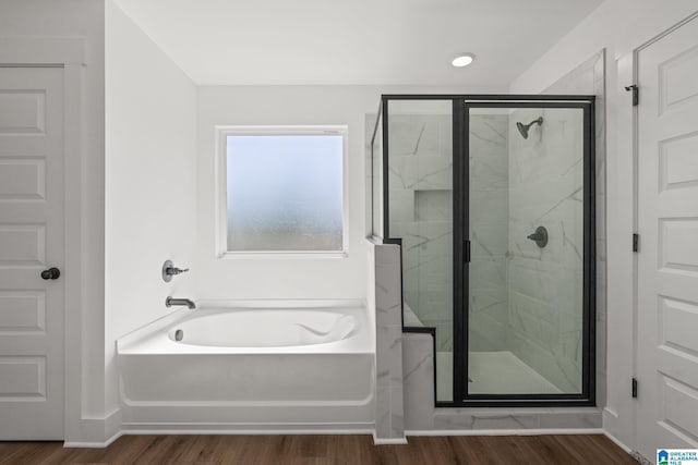 150 Sage Dr, Pell City, AL 35128 - bathroom with a bath, a shower stall, and wood finished floors