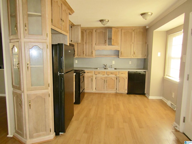 kitchen featuring light wood-type flooring, ornamental molding, sink, black appliances, and light brown cabinets