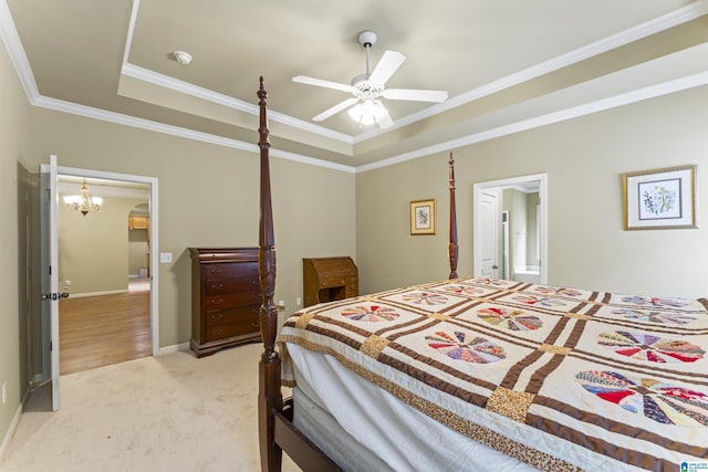 bedroom with a raised ceiling, light carpet, crown molding, and ceiling fan with notable chandelier