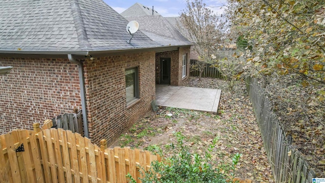 view of side of home with a patio