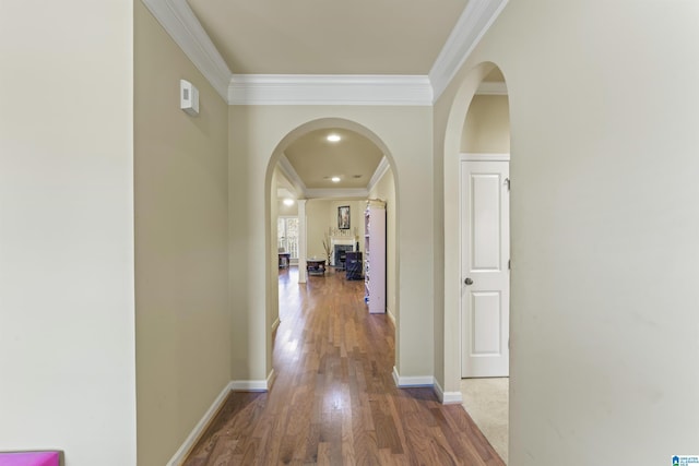 hall featuring wood-type flooring and ornamental molding