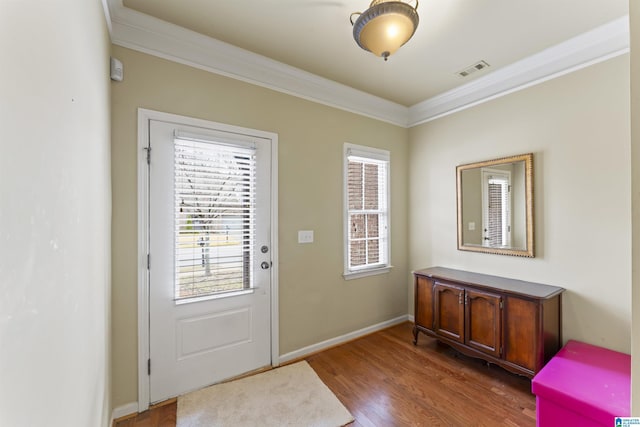 doorway to outside featuring dark hardwood / wood-style flooring and ornamental molding