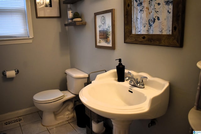 bathroom with tile patterned floors, sink, and toilet