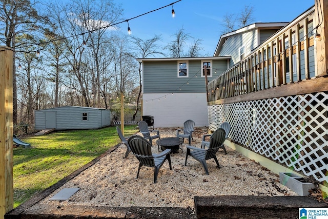 exterior space featuring a fire pit, a storage shed, and a wooden deck