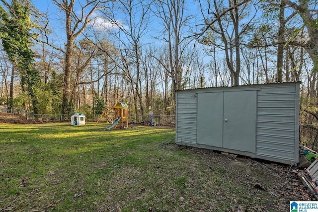 view of yard with a shed and a playground