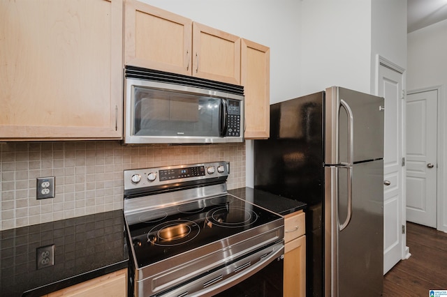 kitchen with light brown cabinetry, backsplash, stainless steel appliances, and dark hardwood / wood-style floors