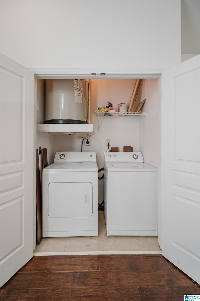 laundry room featuring independent washer and dryer and hardwood / wood-style flooring