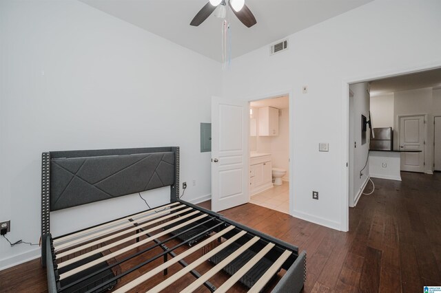 bedroom featuring wood-type flooring, electric panel, ensuite bath, and ceiling fan