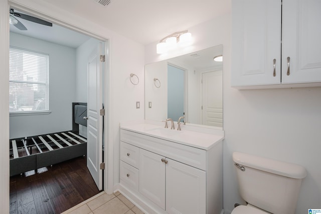 bathroom with ceiling fan, toilet, vanity, and hardwood / wood-style flooring