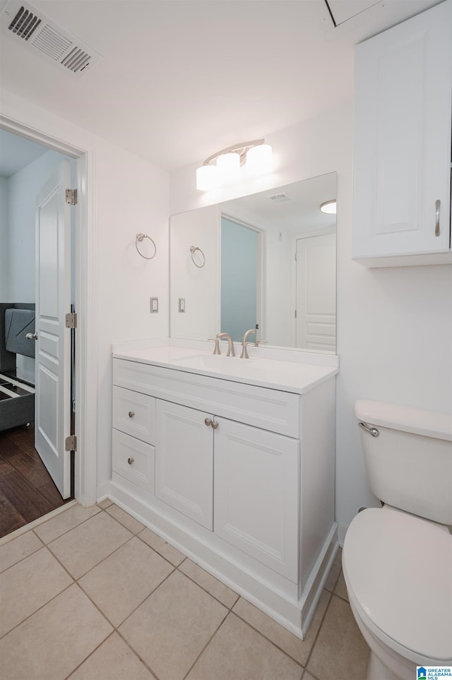 bathroom featuring tile patterned floors, vanity, and toilet