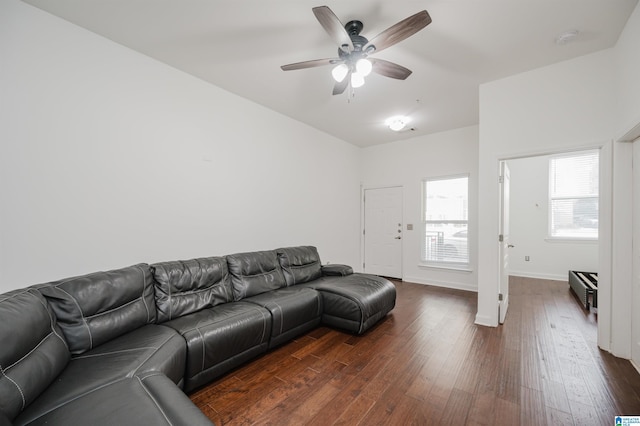 living room featuring ceiling fan and dark hardwood / wood-style flooring