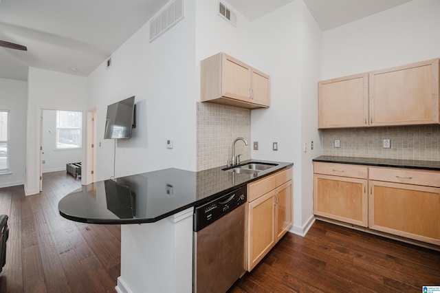 kitchen with dishwasher, sink, dark hardwood / wood-style floors, decorative backsplash, and kitchen peninsula