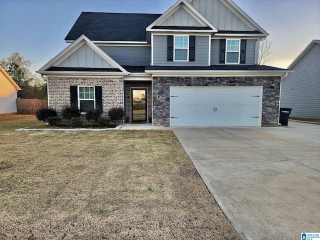 craftsman inspired home with a garage and a yard