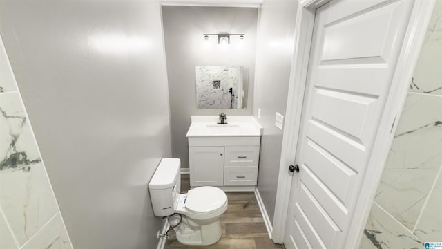 bathroom with hardwood / wood-style floors, vanity, and toilet