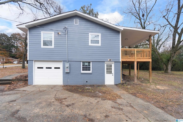 view of side of home featuring a garage and a deck