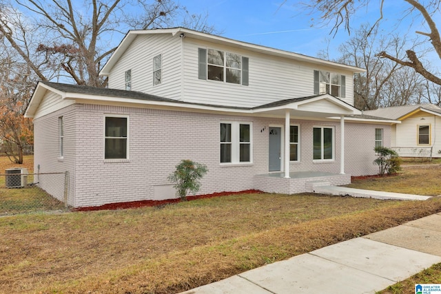 front facade featuring a front lawn and central AC