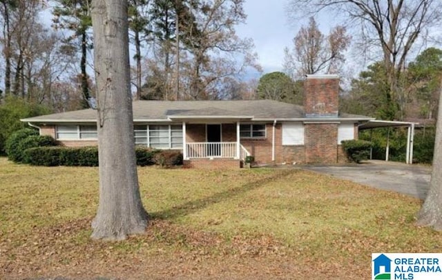 single story home with a carport, covered porch, and a front yard