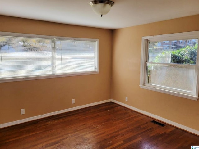 unfurnished room featuring dark hardwood / wood-style floors