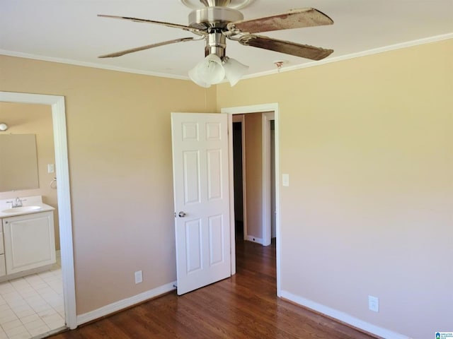 unfurnished bedroom with ceiling fan, light wood-type flooring, ornamental molding, and ensuite bath