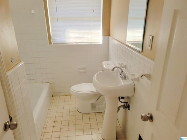 bathroom featuring sink, tile walls, tile patterned flooring, toilet, and a tub