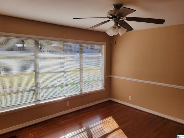 empty room with dark hardwood / wood-style floors and ceiling fan