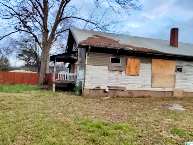 view of property exterior featuring a yard and covered porch