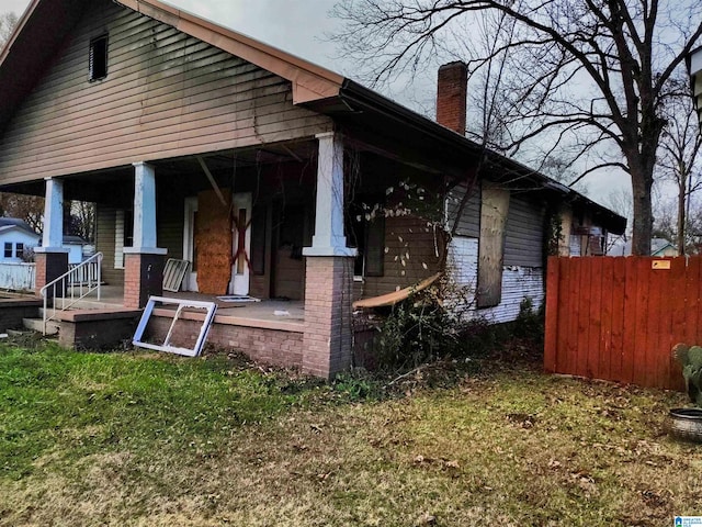 view of side of property with covered porch