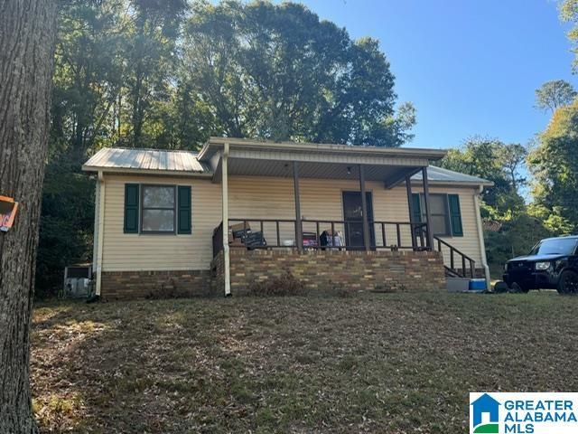 back of house featuring a porch