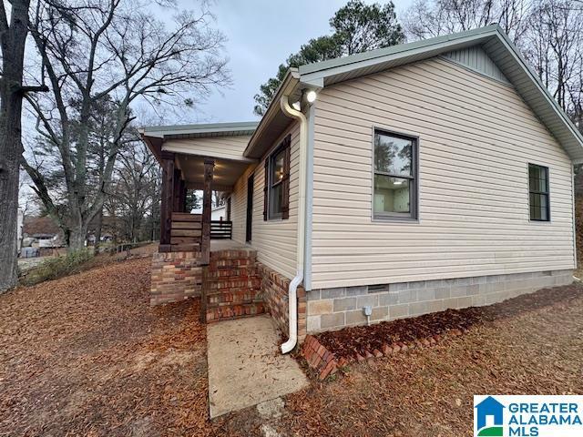 view of side of home with covered porch