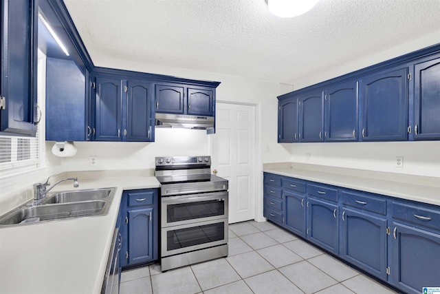 kitchen featuring a textured ceiling, sink, blue cabinetry, light tile patterned floors, and double oven range