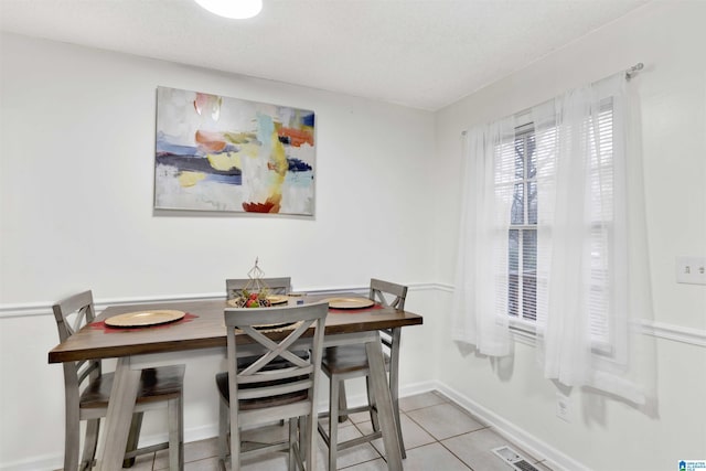 dining area with light tile patterned flooring