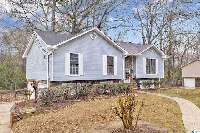 bi-level home with a garage and a front lawn