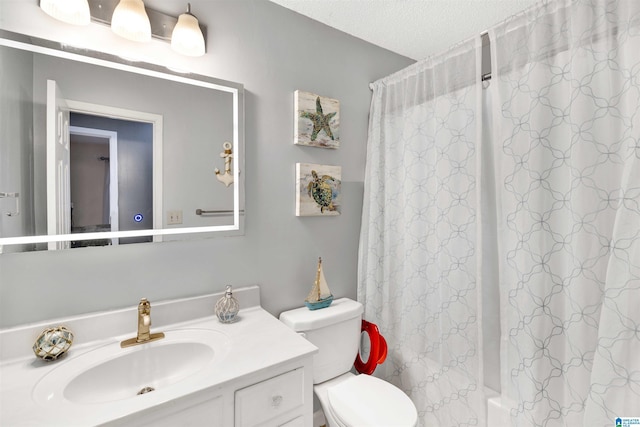 full bathroom featuring shower / tub combo with curtain, vanity, a textured ceiling, and toilet