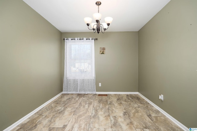 empty room featuring a chandelier